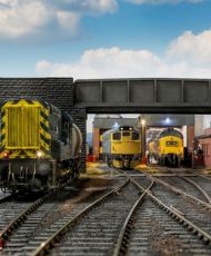 Model railway trains under a bridge